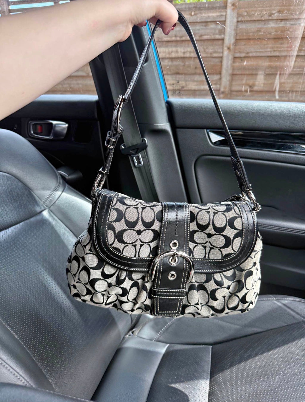 Black and grey coach shoulder bag with adjustable strap