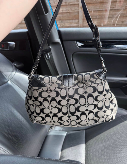 Black and grey coach shoulder bag with adjustable strap